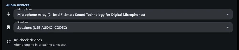 The audio devices section on Windows: a microphone picker, a
              speakers picker, and a re-check devices button.